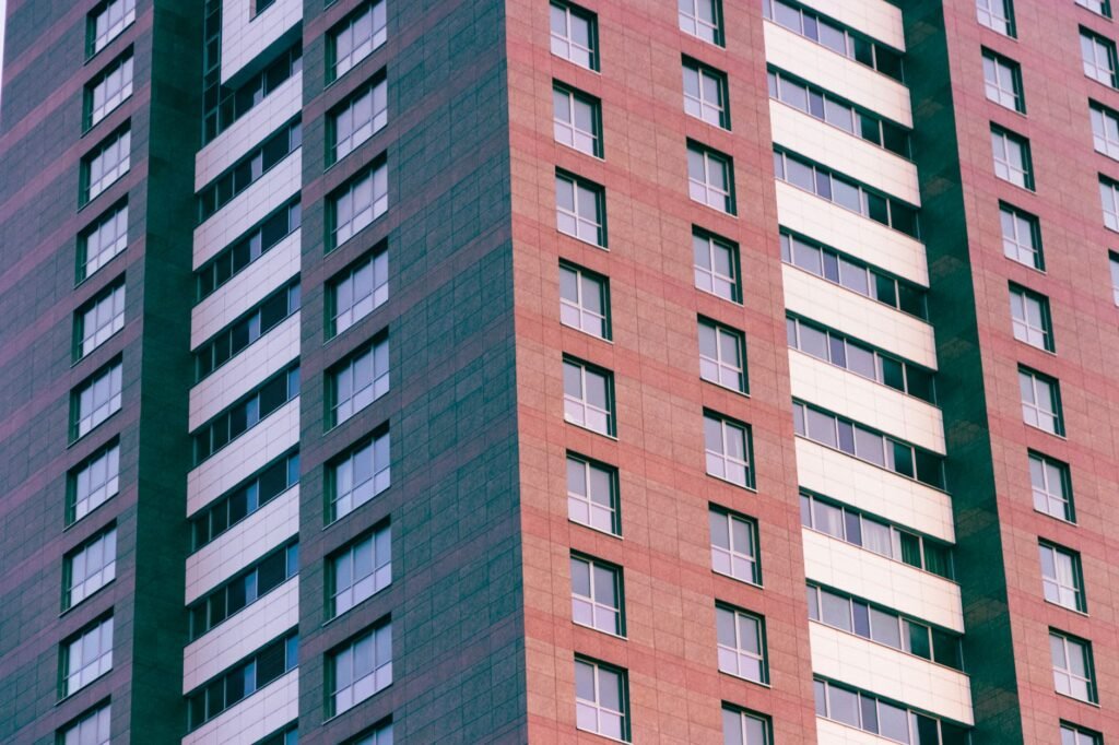 Close-up of a modern high-rise building with glass windows and geometric patterns.